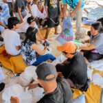 Santa Fe,Bantayan,Philippines - December 18, 2013: People dividing emergency rice supplies into bags after Typhoon Haiyan Yolanda in the Philippines